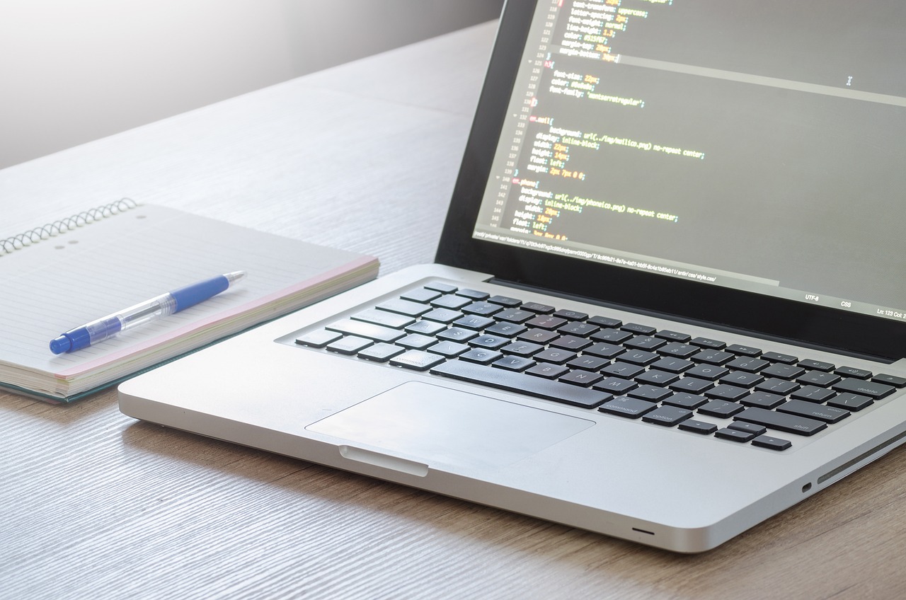 A picture of a laptop with code written on the screen.